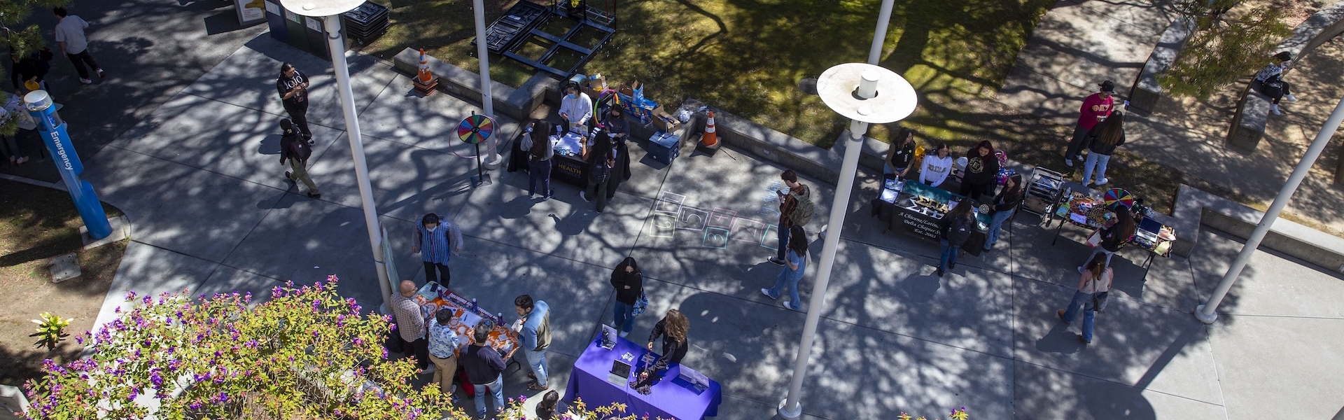 Tabling event on campus with several students walking around